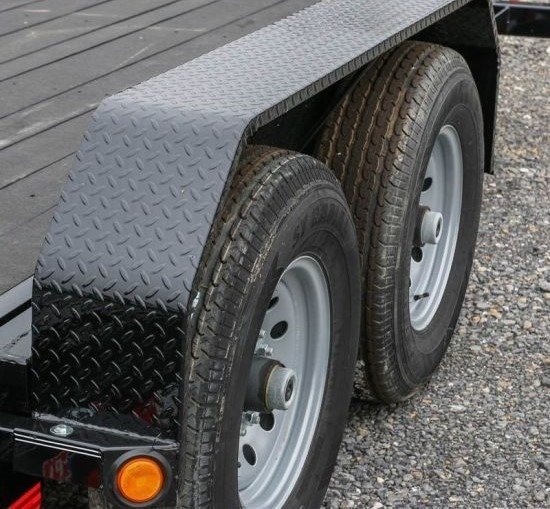 Dual axle trailer with black diamond plate steel fenders, showcasing a durable and heavy-duty design for better protection and style.