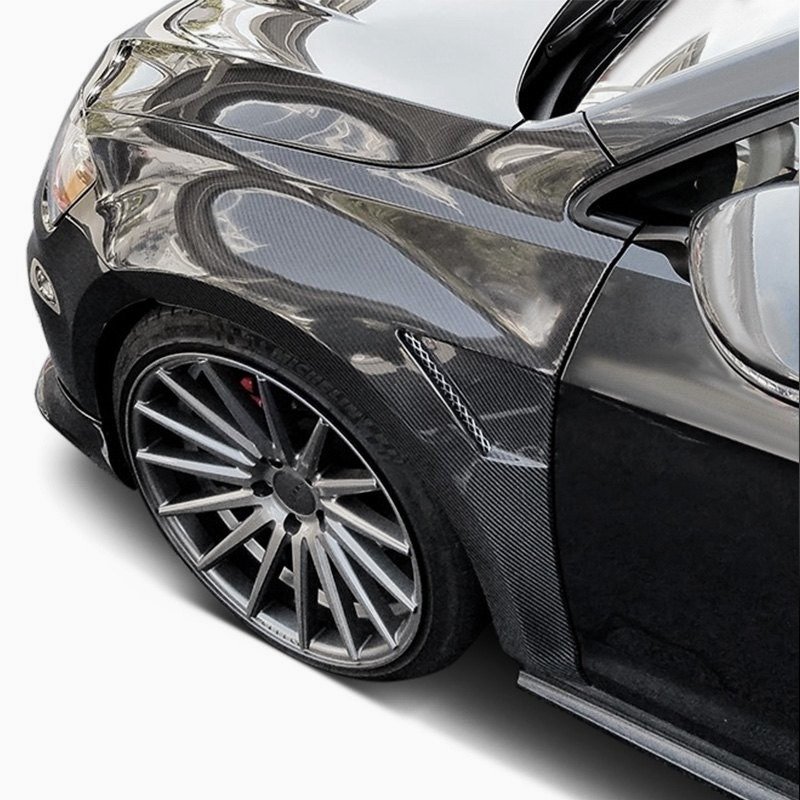 A carbon fiber fender installed on a car, showcasing the sleek and glossy finish with a custom wheel setup