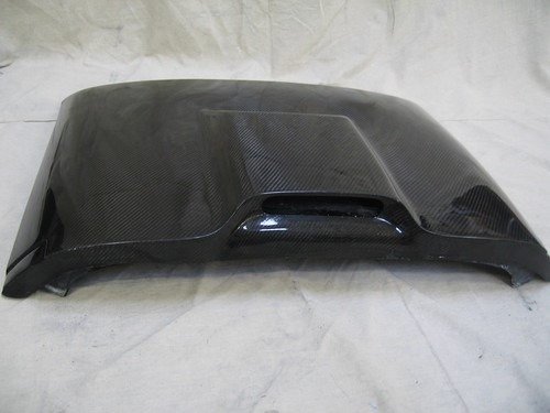 A carbon fiber hood with a vent, showing the lightweight and durable design used in high-performance vehicles