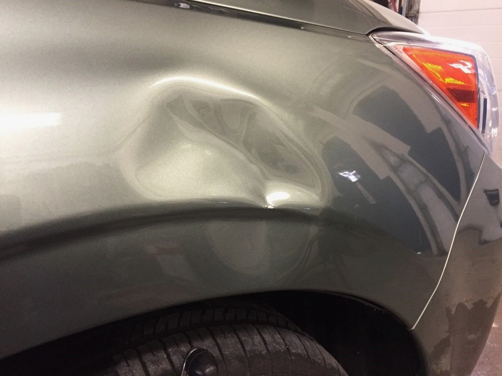 Dented fender that needs unrolling to restore its shape and prevent further damage