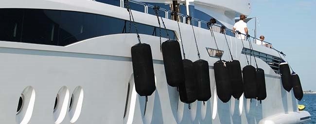 Taylor Made boat fenders securing a boat at a dock, essential for boat protection.