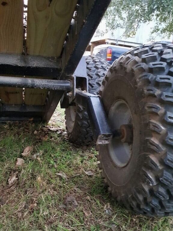 image of a trailer without fenders, with debris like rocks and mud