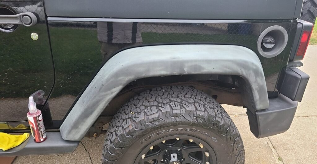 Close-up image of a Jeep fender faded