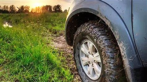 Fenders protecting a car from debris, demonstrating their importance and why they are required on cars.