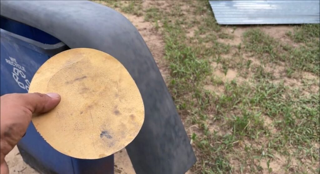 a sandpaper to sand damage areas of a plastic fender